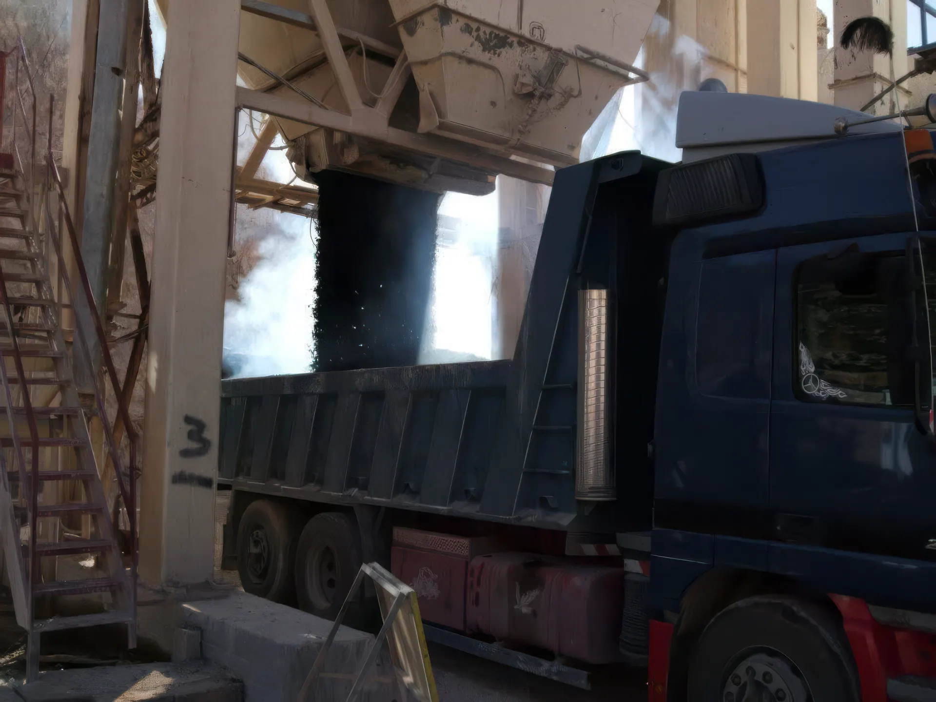 Truck loading hot asphalt mix at the Wadi Samad plant